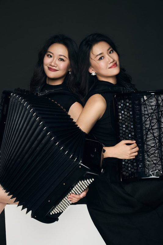 Press photo: the duo in black with accordions
